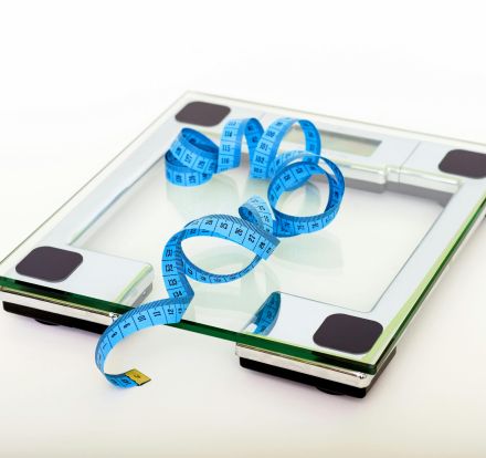 Blue Tape Measuring on Clear Glass Square Weighing Scale